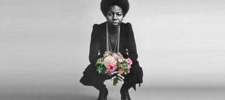 Nina Simone holding flowers.