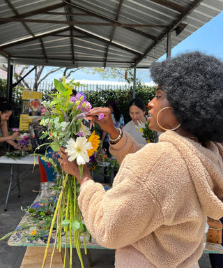 Black woman holding a flower bouquet