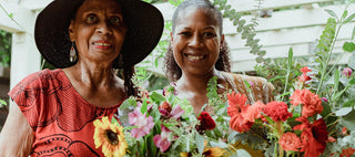 Two woman holding flowers